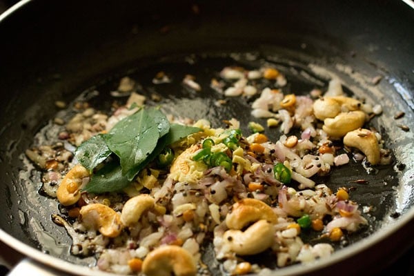 ginger, green chillies, and curry leaves in saucepan