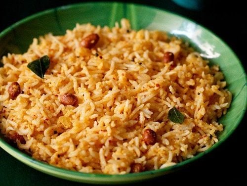 mango rice served in a green plate.