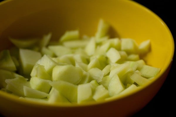 peeled and chopped raw mango in a bowl. 