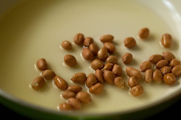 peanuts added to hot oil in a pan. 