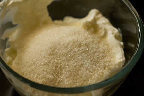 sugar added to bowl with curd for shrikhand recipe