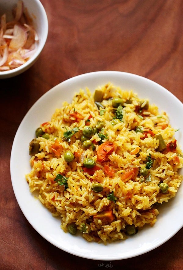 tomato pulao served on a white plate