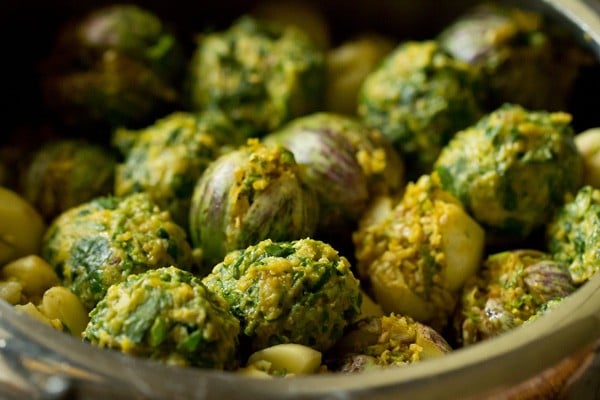 prepared methi muthia placed over the vegetable layer and salt sprinkled on top. 