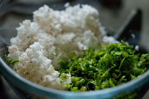 fresh grated coconut and finely chopped coriander leaves added to another bowl for undhiyu recipe.