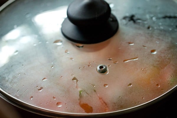 pan covered with glass lid to cook vegetables