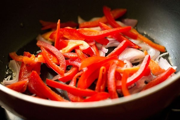 oil, onions and red bell peppers in pan