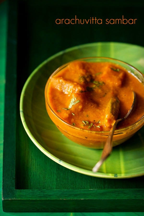 arachuvitta sambar in a bowl with a spoon kept on a green plate