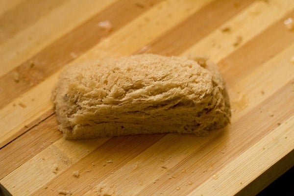 edges of the bread slice pressed and covered to form a rectangular bread cheese roll. 