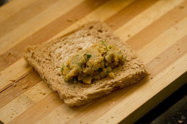 potato-cheese stuffing placed on one side of the flattened bread slice. 
