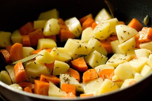 mixing veggies with spices