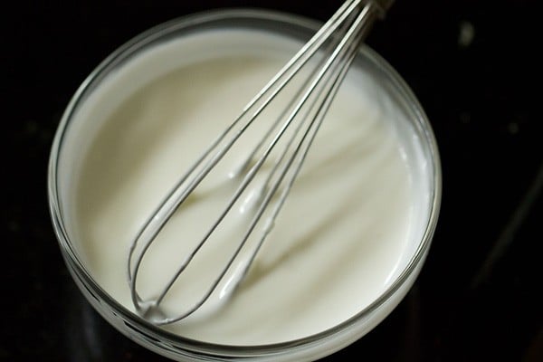 whisking curd in a bowl