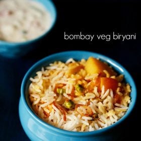 bombay biryani served in a blue bowl with a side of raita and text layover.