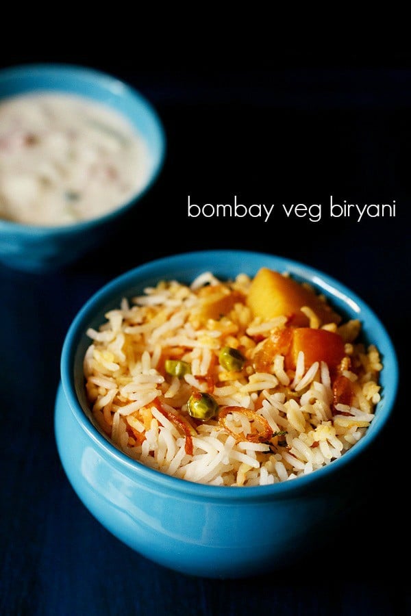 bombay biryani served in a blue bowl with a side of raita and text layover.