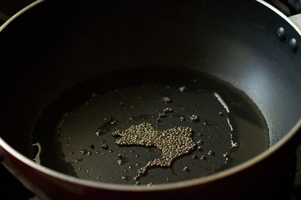 oil and mustard seeds in pan