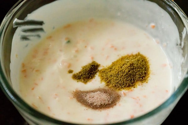 spices added to curd in a bowl