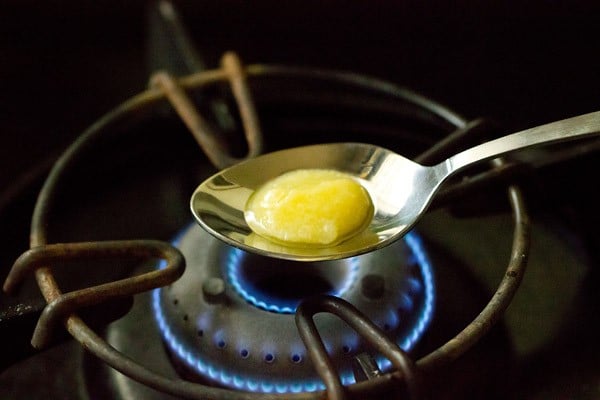 heating ghee in a spoon