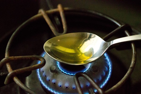 heating ghee in a spoon