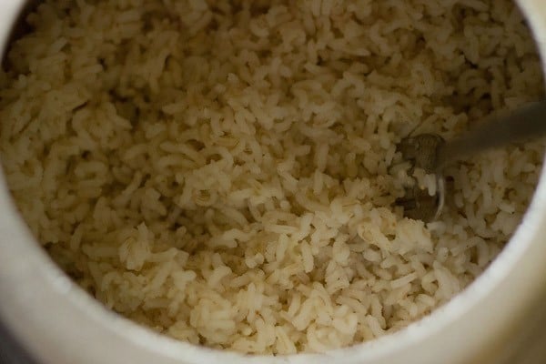cooked rice being fluffed