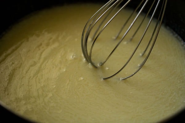 whisking condensed milk with butter