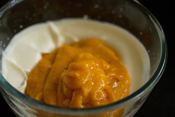 adding mango  to cream for making mousse frosting