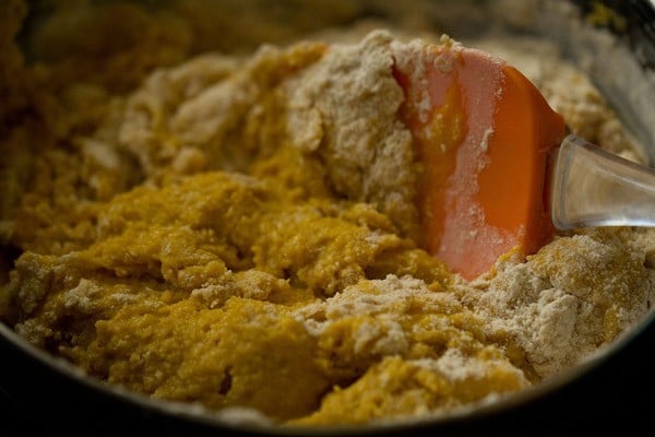 folding eggless mango cake batter with spatula