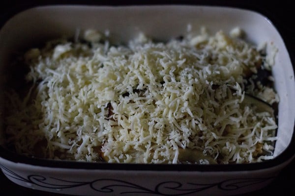 uncooked eggplant parmigiana in an oven dish