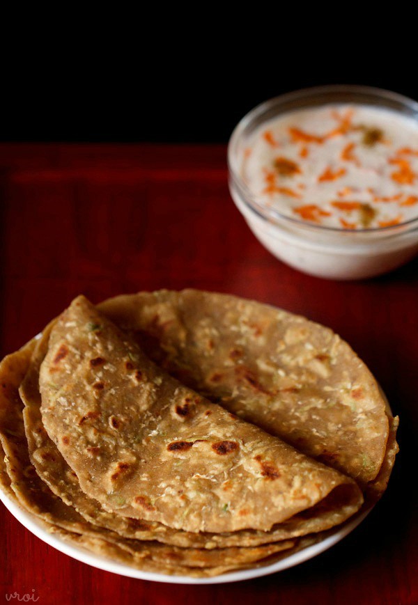 lauki paratha served in a plate with a side of carrot raita