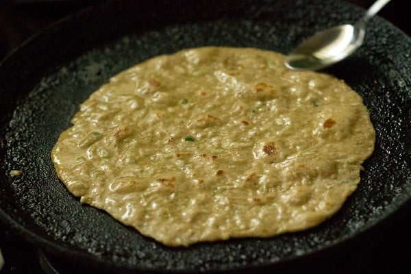 applying ghee on lauki paratha