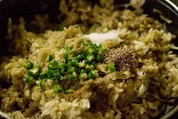 green chilies garam masala powder and carom seeds added to grated lauki