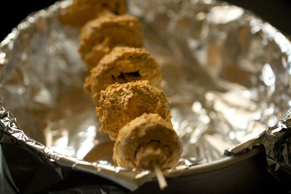 thread the mushroom tikka for baking