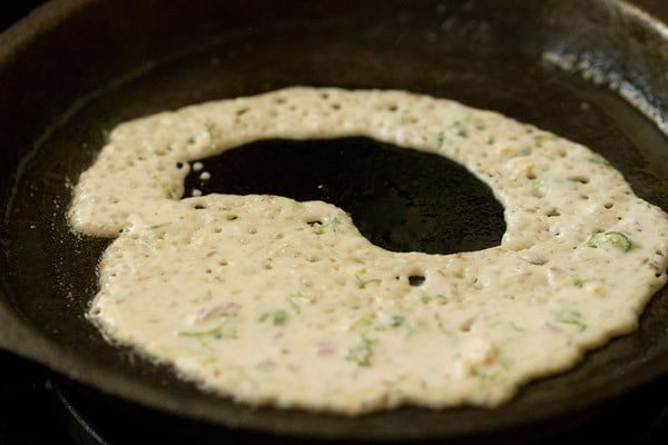 oats dosa batter on pan with gaps