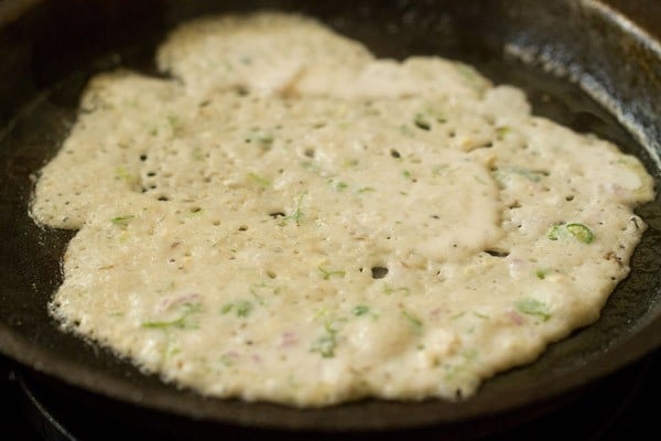 oats dosa on a medium flame