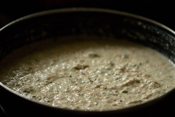 oats idli batter in black bowl.