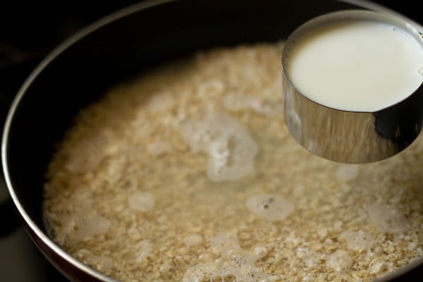 adding milk to the pan.