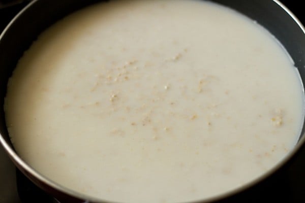 cooking oatmeal porridge in pan.