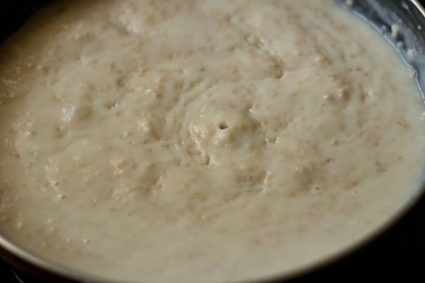 oatmeal porridge cooked and thickened in pan.