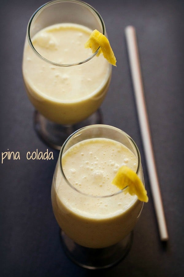 pina colada in stem glasses with text layovers.