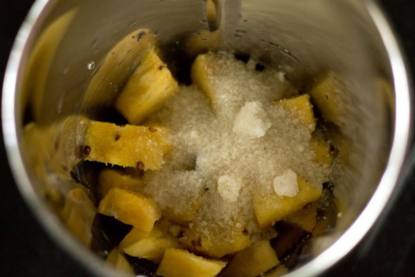 sugar layer on chopped pineapples in blender.