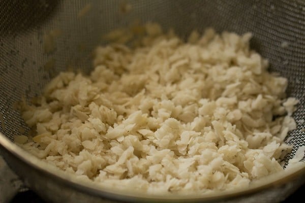 rinsing thick poha for poha upma. 