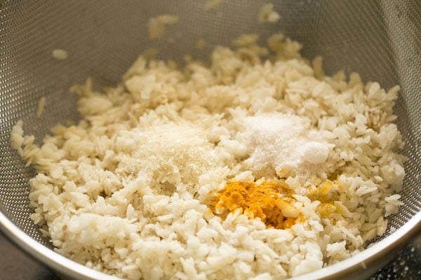 turmeric powder, sugar and salt added to the rinsed poha for poha upma. 