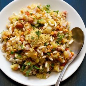 mango chaat served in a white bowl with a steel spoon.