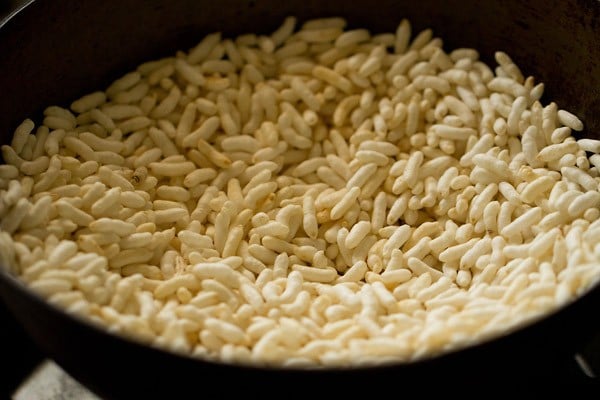 roasting puffed rice in a pan. 