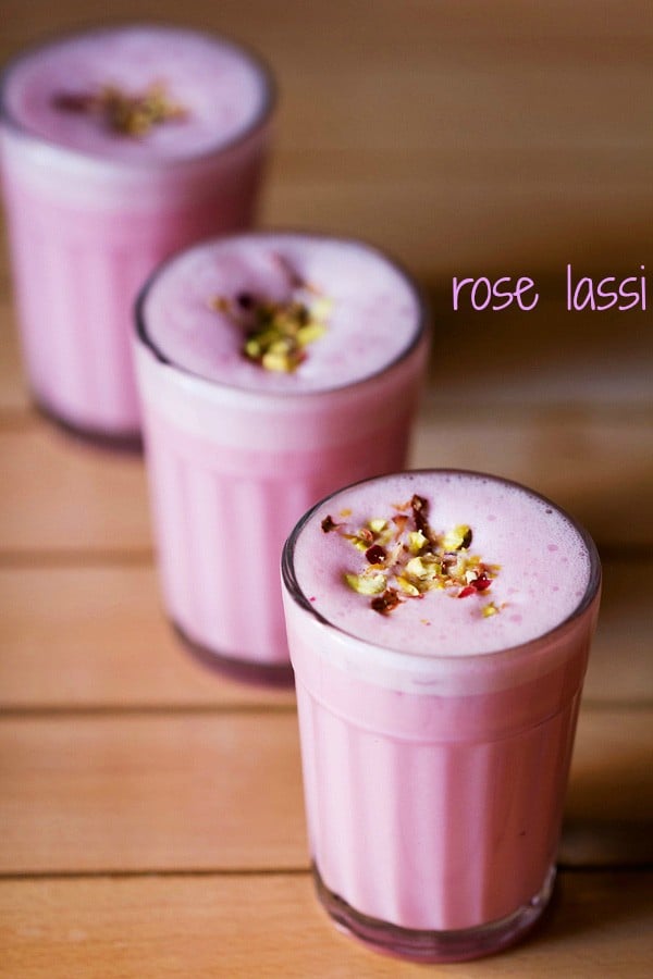rose lassi garnished with chopped nuts, dried rose petals and served in 3 glasses wit text layover.