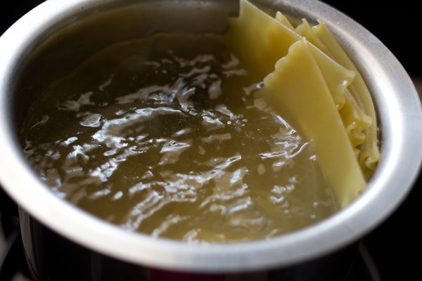 cooking lasagna noodles in boiling water.