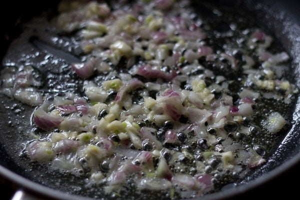 sautéing garlic and onions for spinach mushroom lasagna recipe.