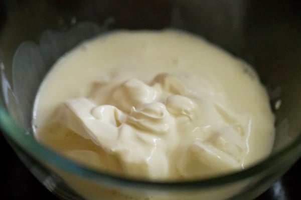 chilled fresh cream added in a bowl. 