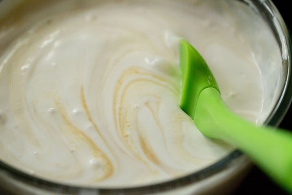 mixing custard sauce in the whipped cream mixture.