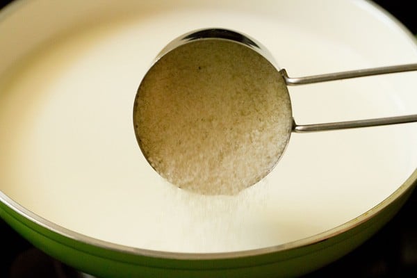 adding sugar to milk.