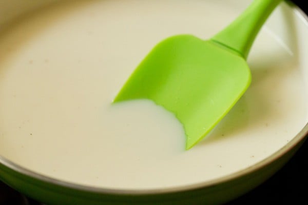 heating the sugar-milk mixture.