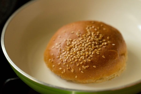 burger buns with the buttered side being lightly toasted in a pan